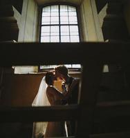 bride and groom on the background of a window. photo