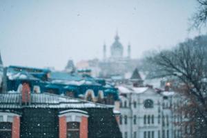 Copious snowfall over the city with the roofs photo