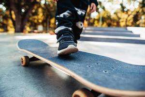 Boy legs on the skateboard close up image photo