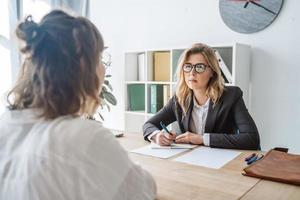 Young female candidate interviewed by employer photo