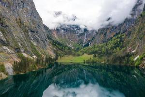 panorama escénico de montaña con prados verdes y el idílico lago turquesa oberer foto