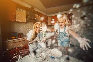 Mother with kids on kitchen photo