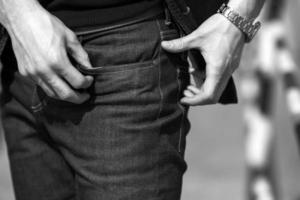 A man dressed in jeans, a close-up shot photo