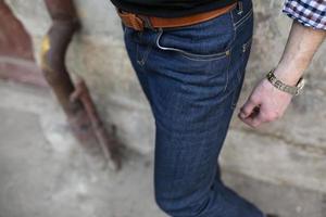 A man dressed in jeans, a close-up shot photo