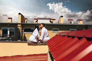 flirting couple with sparkling wine on a roof photo