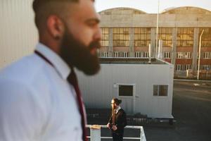 Two bearded businessman looking at something photo