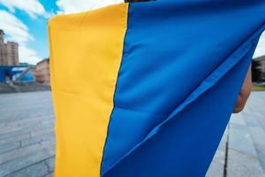 Fabric curved flag of Ukraine. Close up shot, background photo