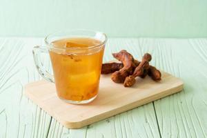 Delicious sweet drink tamarind juice and ice cube photo
