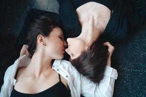 Two beautiful girls lie on the floor photo