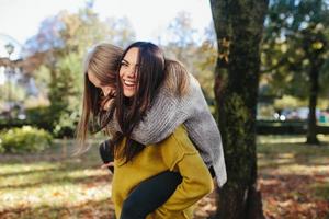 Two girls having fun in the park photo