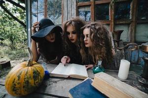 Three vintage witches perform magic ritual photo