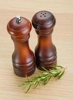 Pepper mill on wooden background photo