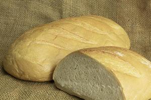 Fresh handmade bread on sackcloth background photo