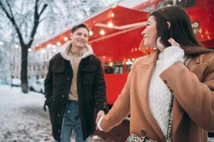 beautiful young couple walking down the street photo