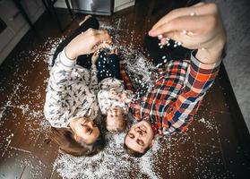 Happy family playing together on the floor photo