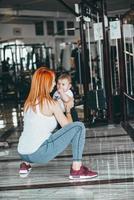 Young mother with her young son in the gym photo