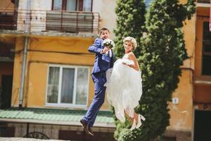 couple jumping on the street photo