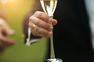 groom gives the bride champagne photo