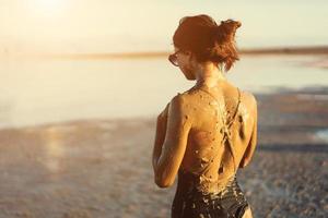 A young woman enjoying the natural mineral mud photo