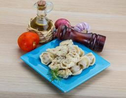 Russian dumplings on the plate and wooden background photo