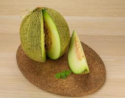 Melon on wooden board and wooden background photo