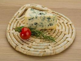 Blue cheese on wooden board and wooden background photo