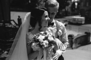 bride and groom posing on the streets photo