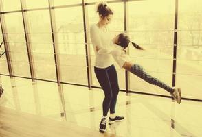 Mother twist her daughter in the gym photo