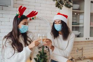 Two girls chatting, gossiping in the kitchen on new year's eve photo