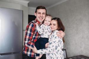 Mom, Dad and little girl having fun together photo