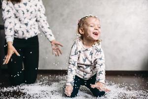 Little girl is playing with foam balls photo