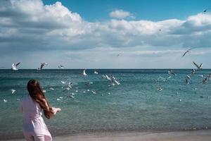 Beautiful unusual woman walking on the beach photo