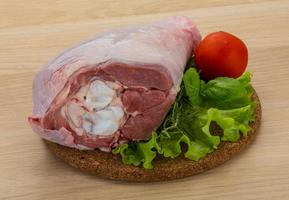 Turkey leg on wooden board and wooden background photo