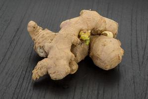 Ginger on wooden background photo