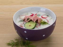 Okroshka in a bowl on wooden background photo