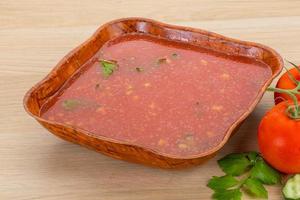 Gaspacho in a bowl on wooden background photo