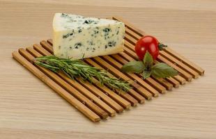 Blue cheese on wooden board and wooden background photo