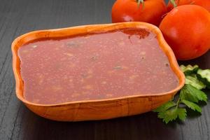 Gaspacho in a bowl on wooden background photo