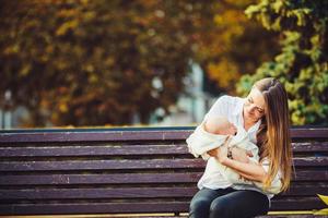 mother and two daughters rest on a bench photo