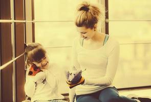 Mother and daughter playing with toys in the gym photo