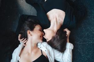 Two beautiful girls lie on the floor photo