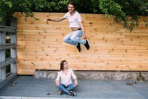 couple posing on a background of the wooden wall photo