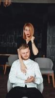 A young woman and her boyfriend are posing for the camera indoors. photo