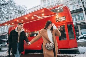 beautiful young couple walking down the street photo