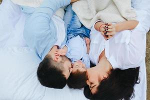 Happy family relaxing together on the mattress photo