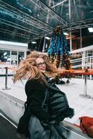 Beautiful young woman poses on the street at night photo