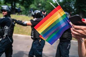 Hand hold a gay lgbt flag at LGBT gay pride parade festival photo