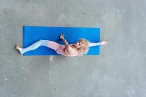 Young slim blond woman making yoga exercises photo