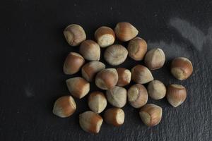 Hazelnut nut isolated on black stone background photo