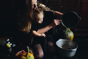 mother and daughter playing together at home photo